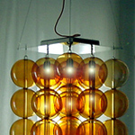 <p><strong><a href=johanna-grawunder.html class=link-lightbox>Johanna Grawunder</a></strong><br />Pillow Talk</p><p><strong>27 Spheres Orange</strong></p><p> Hanging lamp with four adjustable steel cables  and body in stainless steel. 27 suspended spheres in transparent orange blown  glass. 4 lights bulbs.<br />52 x 52 x h. 60 cm.</p><p>Limited edition of 12 signed and numbered  pieces.</p>